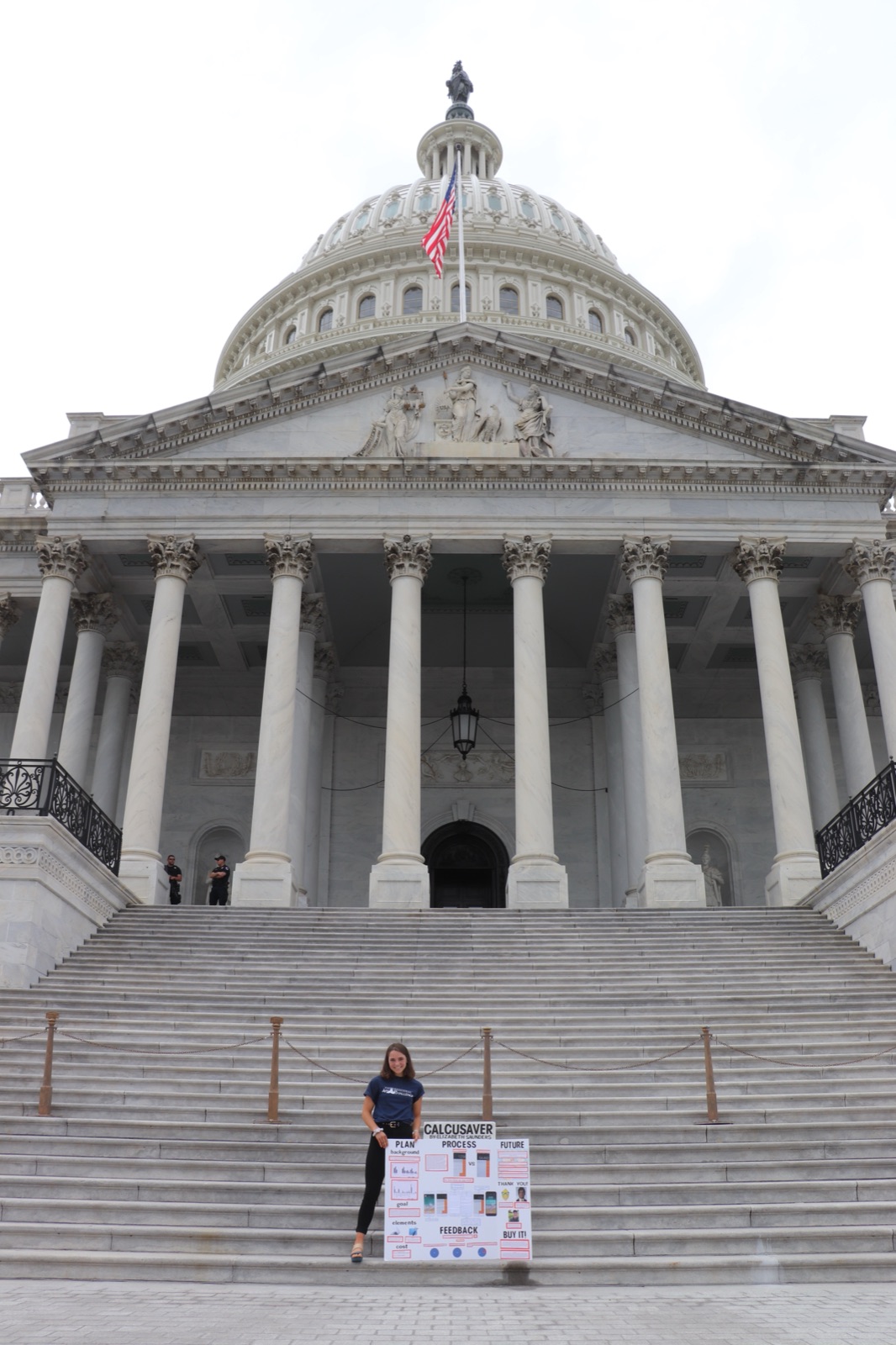 Elizabeth Saunders holding her CalcuSaver poster on the steps of the U.S. Capitol