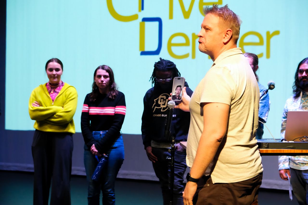 The Give5 Mile High team FaceTiming in a remote collaborator during a presentation