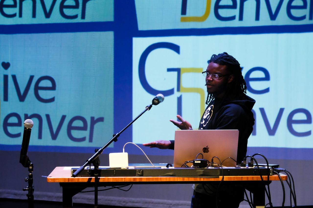 Shawn Duncan presenting Give5 Mile High on stage at the Give Denver launch